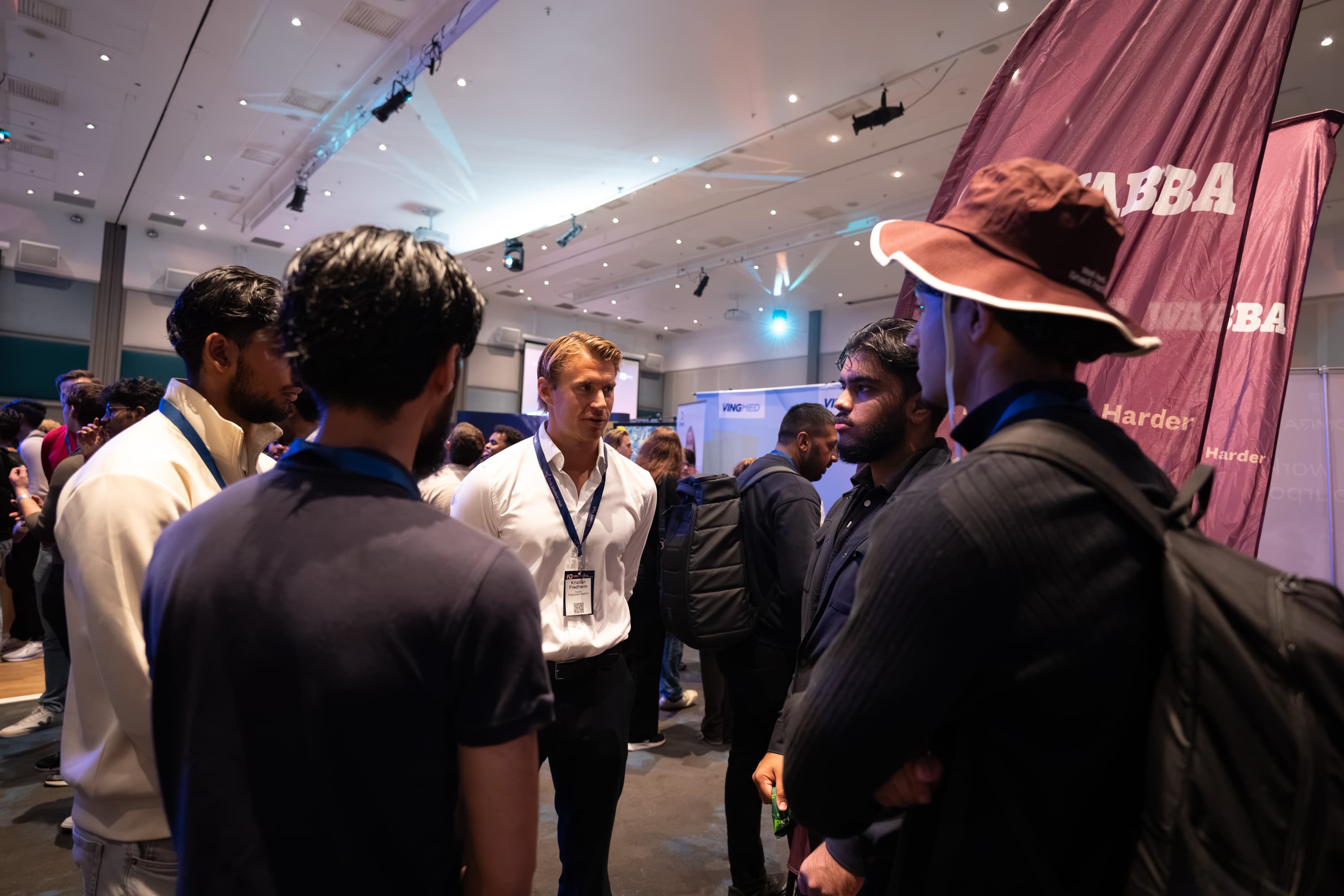 Students speaking with a company representative at a stand.